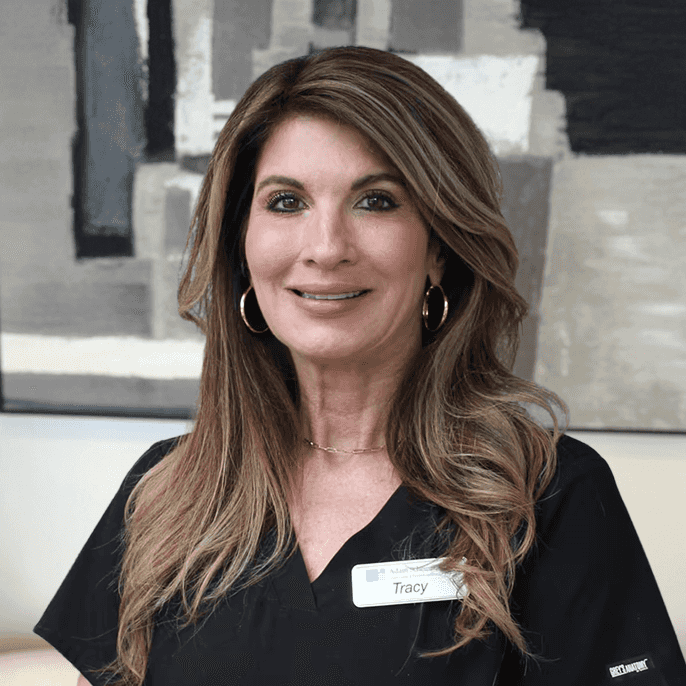 Tracy in black scrubs.