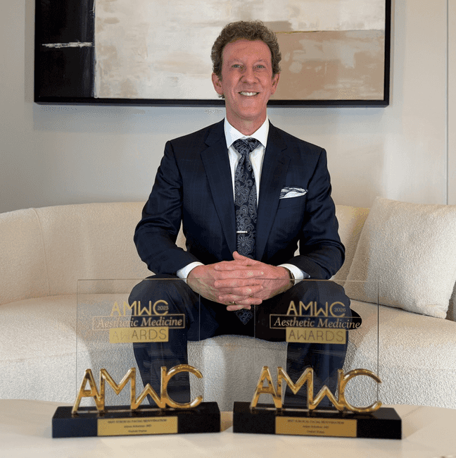 Dr. Adam Scheiner with his AMWC Best Surgical Facial Rejuvenation awards.
